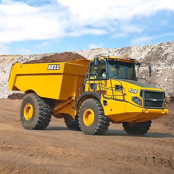 Yellow Bell B30E articulated dump truck in action at a construction site, showcasing heavy machinery efficiency.