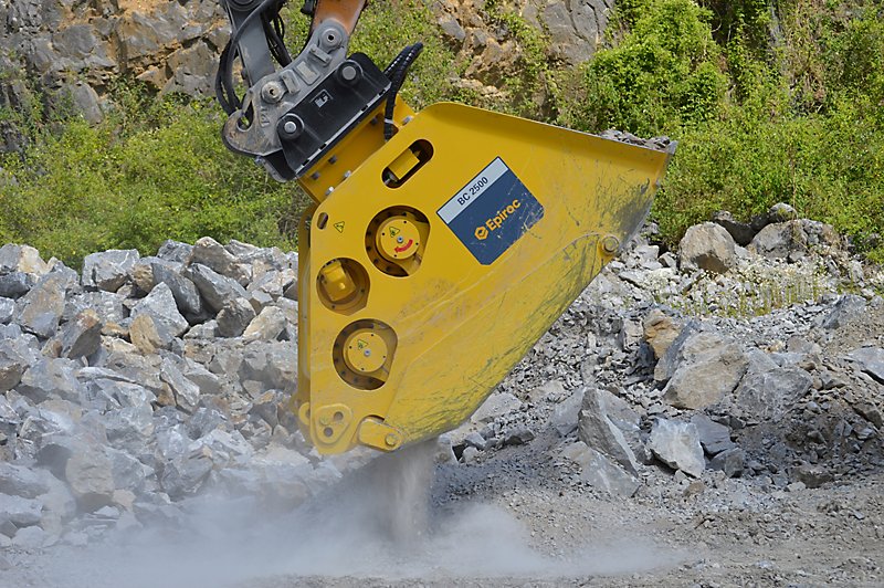 Epiroc BC 2500 crusher breaking rocks at a construction site. Efficient rock crushing machinery for heavy-duty projects.