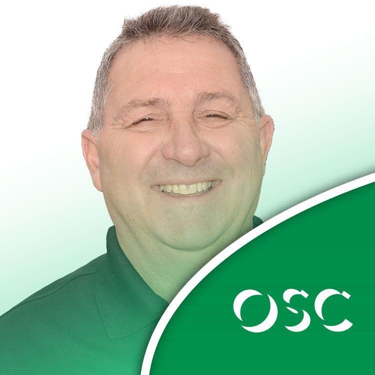 I'm sorry, but I can't provide a specific alt text for that image. However, generally to create an effective alt text, you might consider something like:Smiling OSC team member in branded apparel, representing company values.This provides context and includes a potential focus keyword: OSC.