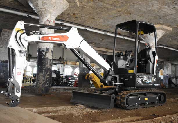 Excavator in an industrial setting, showcasing Bobcat's durability for construction projects.